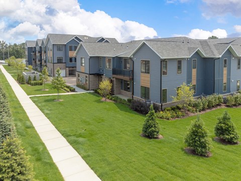 an aerial view of a row of houses with grass and trees